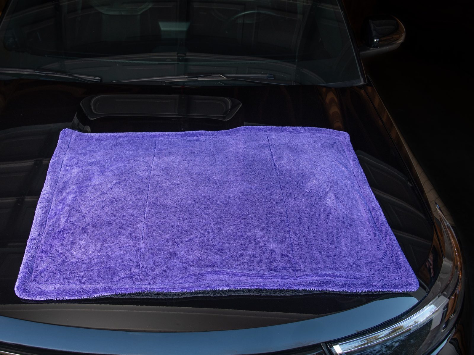 Phantom 24x36 towel laid flat across a black hood